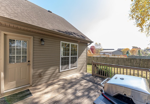 wooden deck featuring a grill