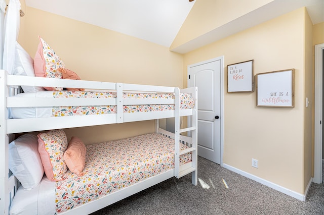 bedroom featuring carpet and vaulted ceiling