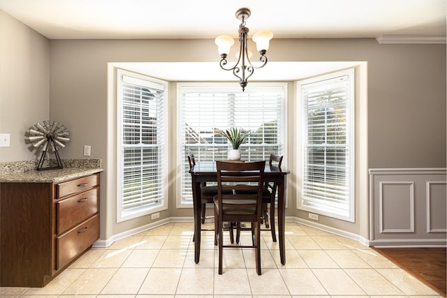 dining room with light tile patterned floors and a chandelier