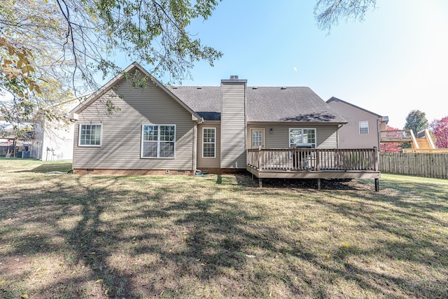 rear view of house with a yard and a wooden deck