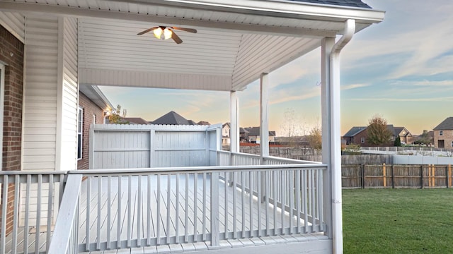 exterior space featuring ceiling fan and fence