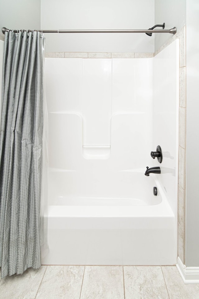 full bathroom with shower / bath combo and tile patterned floors