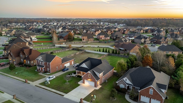 aerial view at dusk featuring a residential view