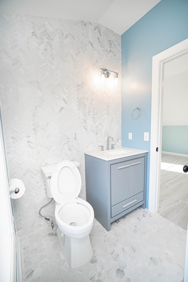 bathroom featuring toilet, tile patterned floors, and vanity