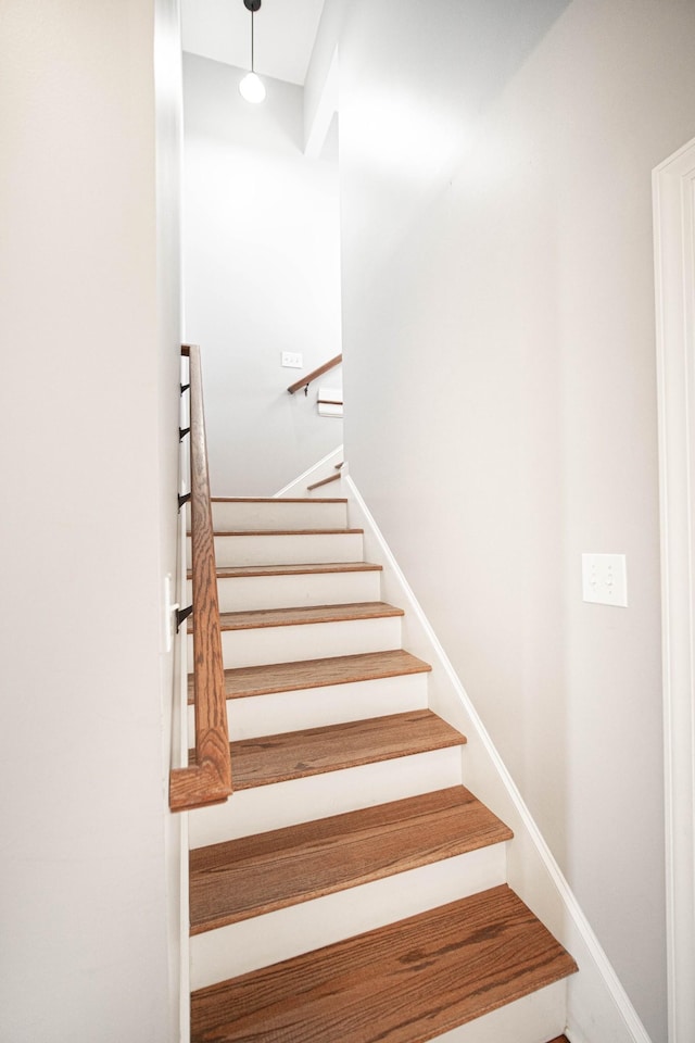 staircase featuring baseboards