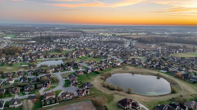 birds eye view of property featuring a water view and a residential view