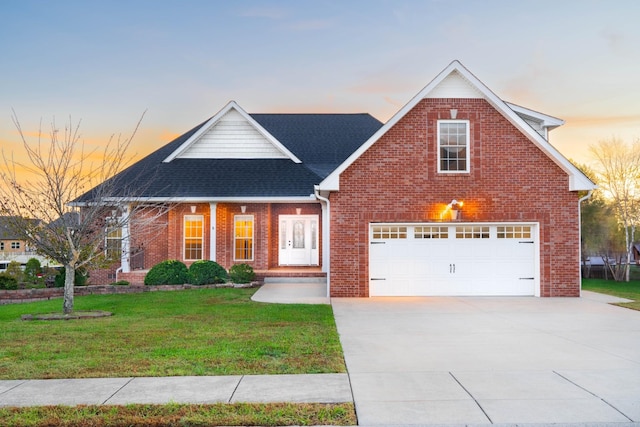 view of front of house with driveway, a front yard, and brick siding