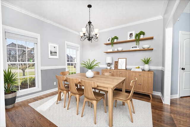 dining space featuring crown molding, dark wood finished floors, and an inviting chandelier