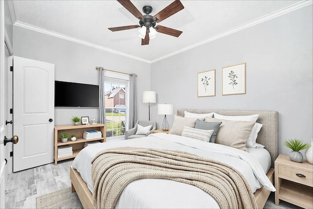 bedroom with light wood-style floors, ceiling fan, and ornamental molding