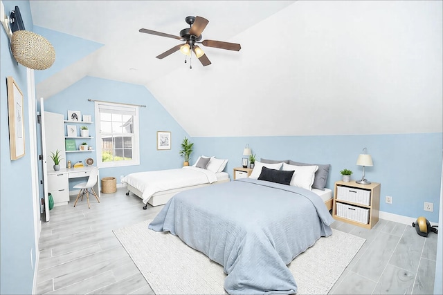 bedroom featuring vaulted ceiling, light wood finished floors, a ceiling fan, and baseboards