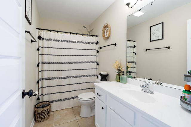 bathroom featuring toilet, tile patterned floors, and vanity