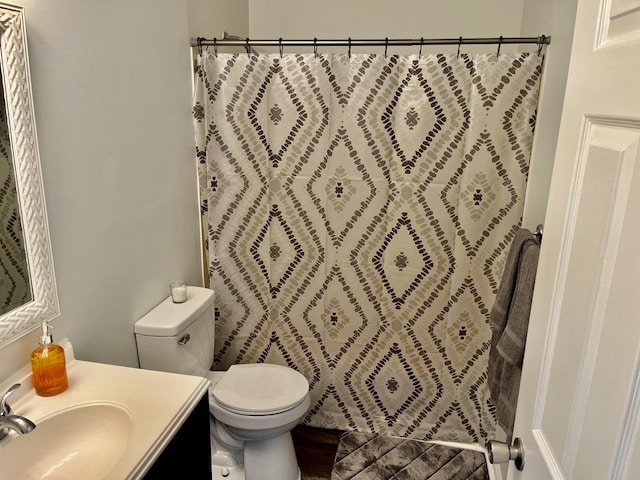 bathroom featuring hardwood / wood-style floors, toilet, vanity, and a shower with curtain