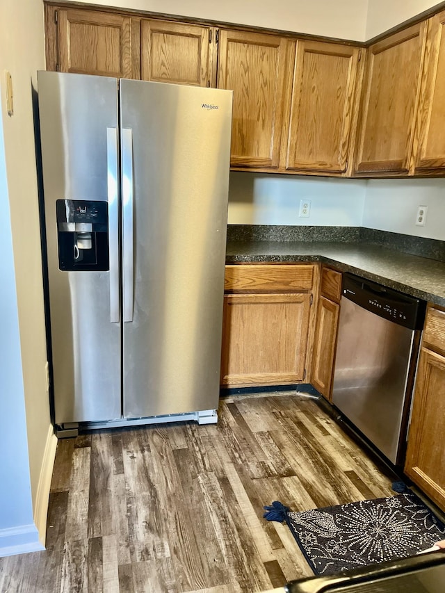 kitchen with dark wood-type flooring and appliances with stainless steel finishes