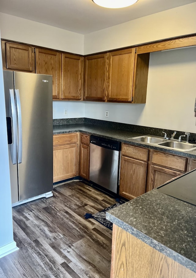 kitchen featuring dark wood-type flooring, appliances with stainless steel finishes, and sink