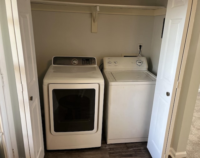 laundry area with dark wood-type flooring and washer and dryer