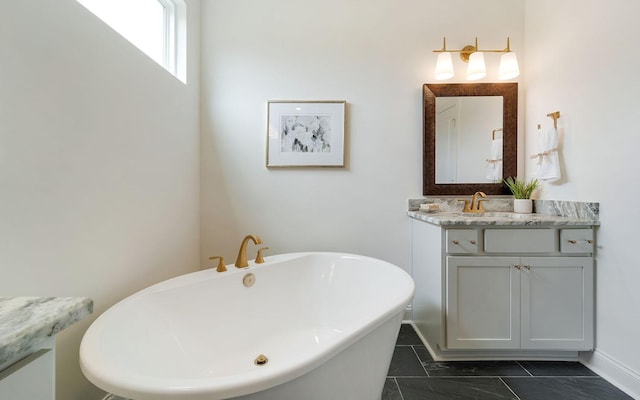 bathroom with tile patterned flooring, vanity, and a bathtub