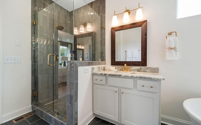 bathroom with tile patterned floors, a shower with shower door, and vanity