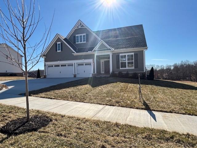 view of front of home with a garage and a front yard