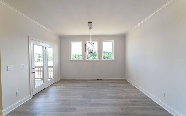 7934 Pine St, Fairview, TN 37062 - unfurnished dining area featuring healthy amount of natural light, ornamental molding, light wood finished floors, baseboards, and a chandelier