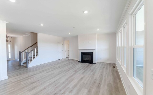 7934 Pine St, Fairview, TN 37062 - unfurnished living room featuring light wood-style floors, stairway, ornamental molding, baseboards, and a fireplace with flush hearth