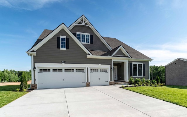 7934 Pine St, Fairview, TN 37062 - craftsman house featuring a front lawn, driveway, roof with shingles, and a garage