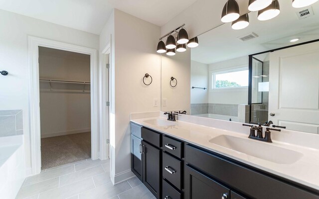 7934 Pine St, Fairview, TN 37062 - bathroom with a garden tub, a walk in closet, double vanity, a stall shower, and tile patterned floors