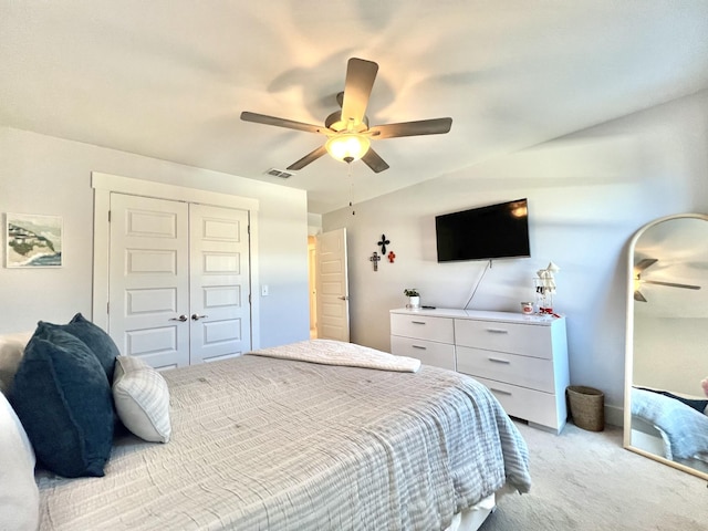 carpeted bedroom with ceiling fan and a closet