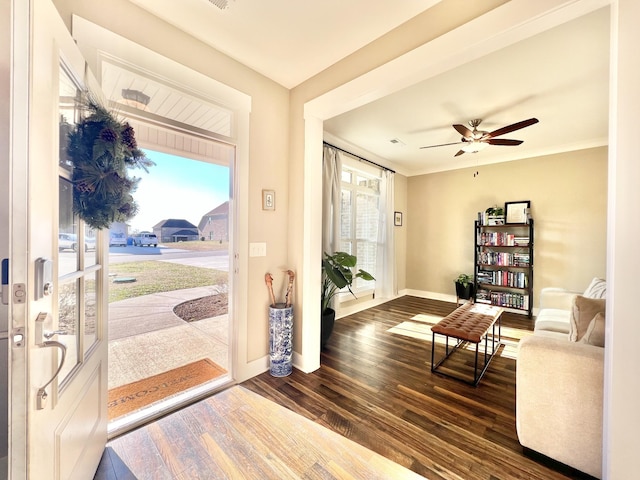 entryway featuring ceiling fan, dark hardwood / wood-style floors, and crown molding