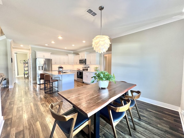 dining room featuring dark wood-type flooring and ornamental molding