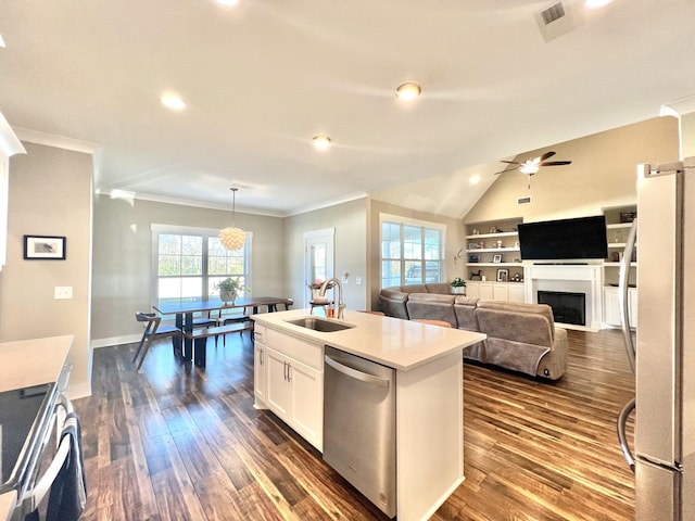 kitchen featuring ceiling fan, sink, hanging light fixtures, appliances with stainless steel finishes, and white cabinets