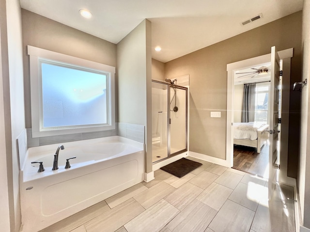 bathroom featuring separate shower and tub