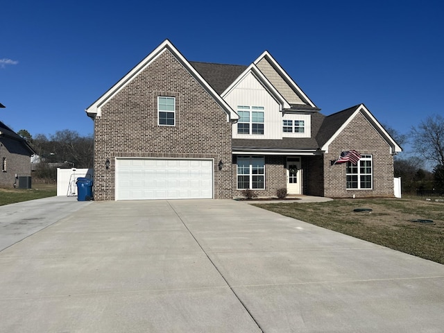 view of front of property with a garage and central air condition unit