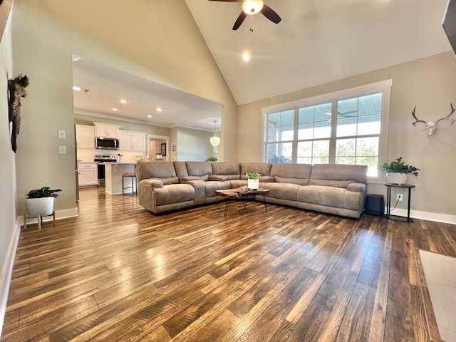 living room featuring ceiling fan, dark hardwood / wood-style floors, and high vaulted ceiling