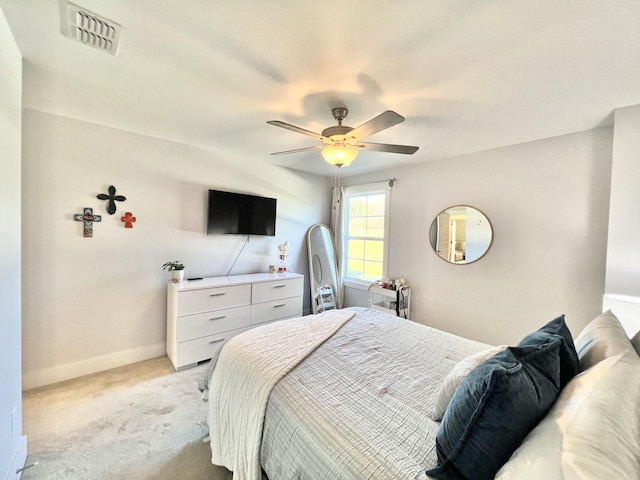 bedroom featuring light carpet and ceiling fan