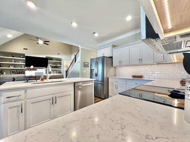 kitchen featuring ceiling fan, backsplash, sink, appliances with stainless steel finishes, and white cabinets