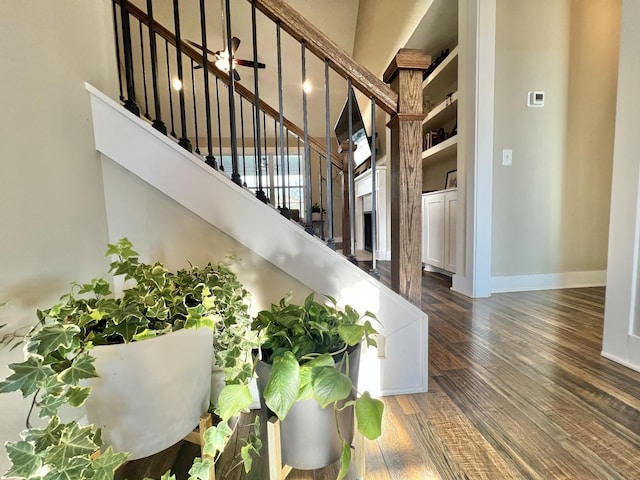 stairs with a high ceiling and wood-type flooring