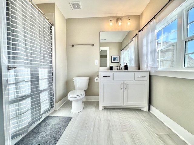 bathroom with toilet and vanity