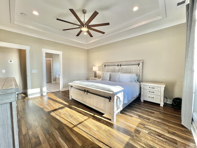 bedroom with ceiling fan, dark wood-type flooring, and a tray ceiling