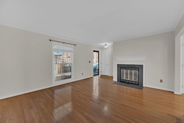 unfurnished living room with ornamental molding and hardwood / wood-style flooring