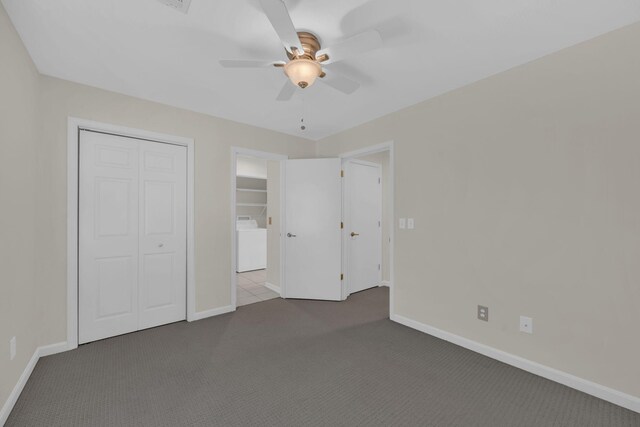 unfurnished bedroom with ceiling fan, a closet, carpet floors, and washer / clothes dryer