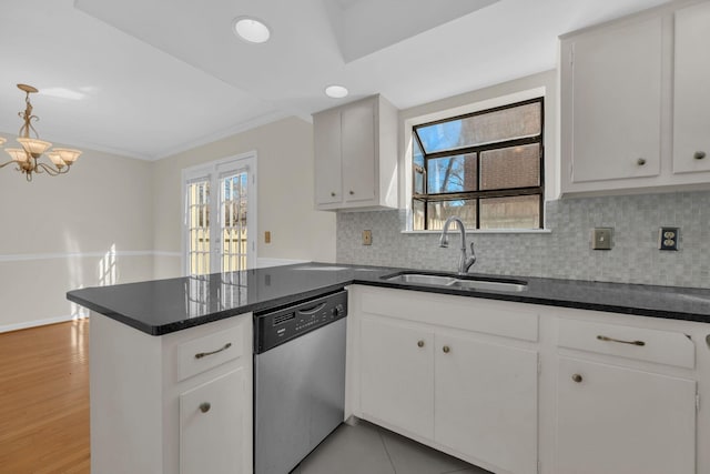 kitchen with kitchen peninsula, dishwasher, white cabinets, and sink