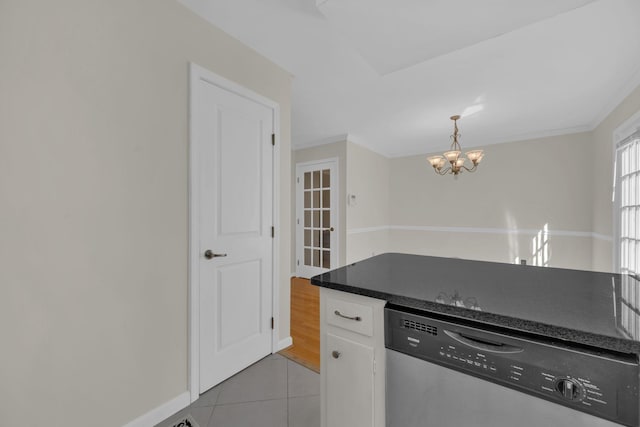 kitchen featuring white cabinetry, light tile patterned flooring, a chandelier, pendant lighting, and stainless steel dishwasher