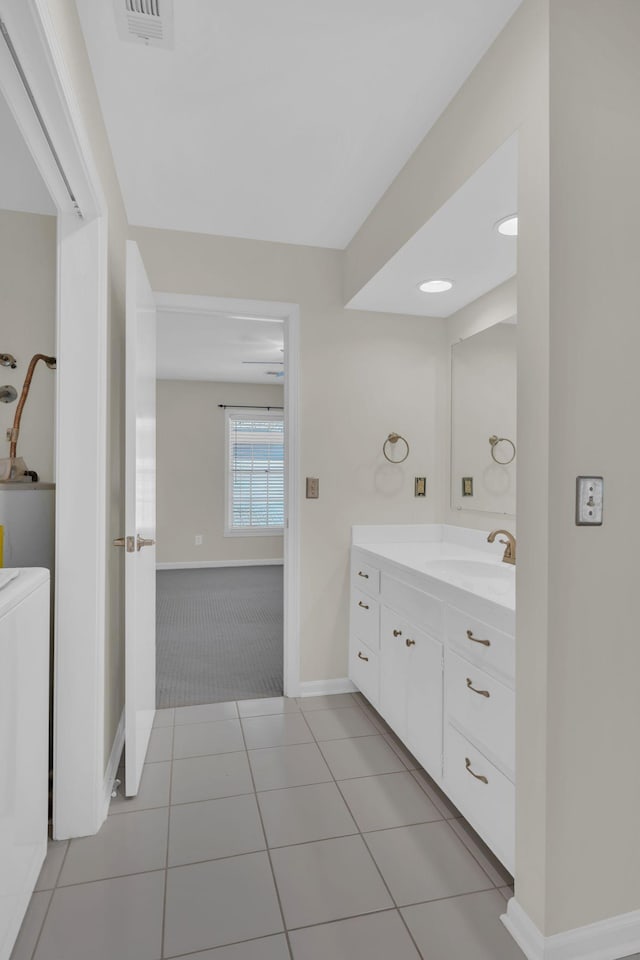 bathroom with washer / clothes dryer, tile patterned flooring, and vanity