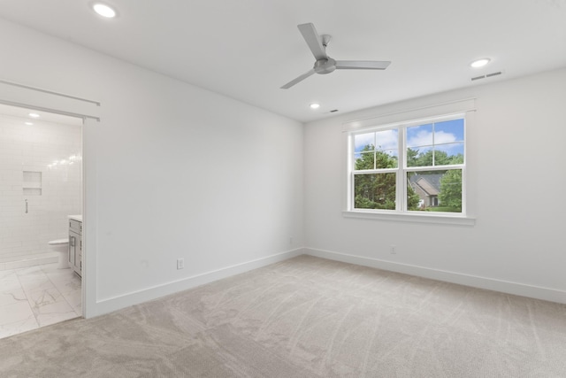 carpeted empty room featuring ceiling fan