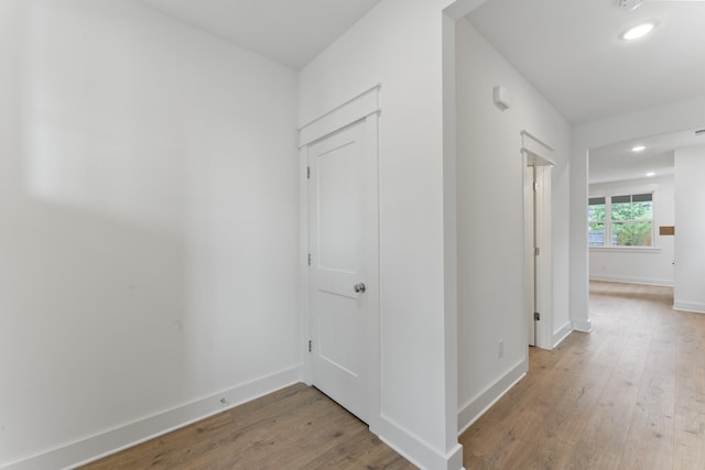 hallway with wood-type flooring