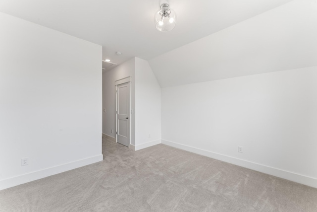 additional living space with light colored carpet and lofted ceiling