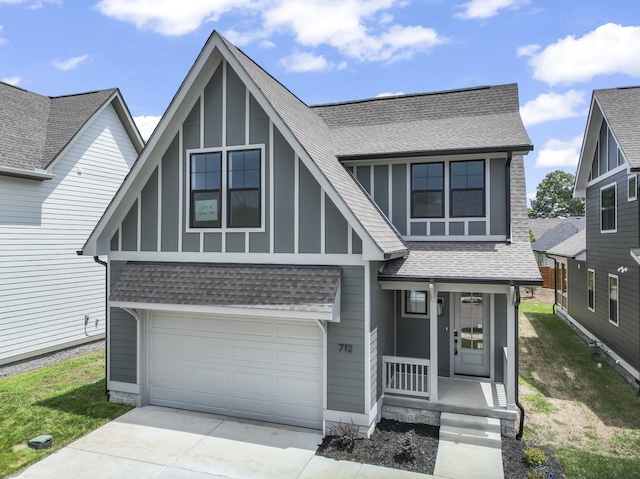 tudor house featuring a garage and a porch