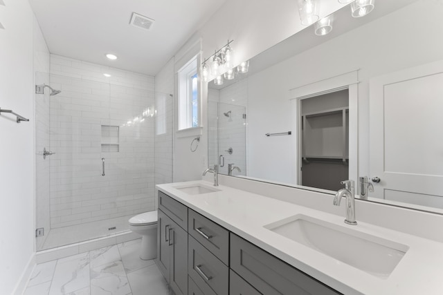 bathroom with vanity, toilet, and an enclosed shower