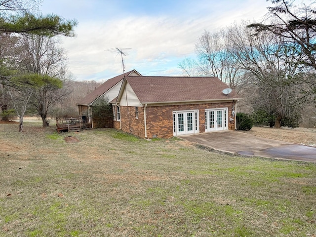 back of property featuring french doors and a yard