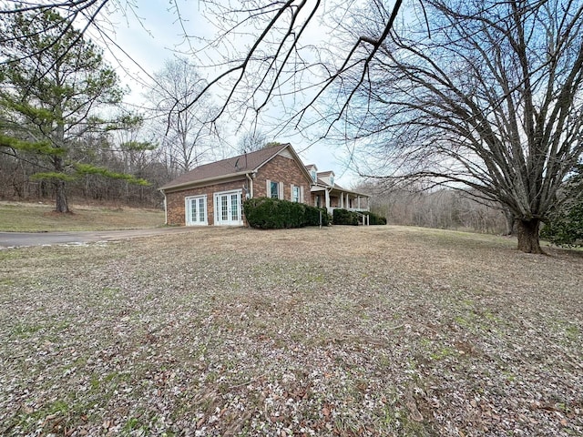 view of side of property with french doors